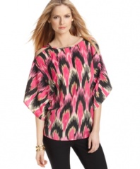 A bold global-inspired print makes a chic statement on this stylishly slouchy MICHAEL Michael Kors top -- sleeve cutouts show a hint of skin!