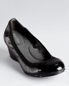 Trimmed in elastic for flexible comfort, Calvin Klein's Prizma wedges boast a walkable 2 heel.