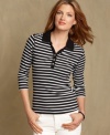 The polo top gets a sporty-chic update with stripes and a V-neckline in Tommy Hilfiger's preppy must-have.
