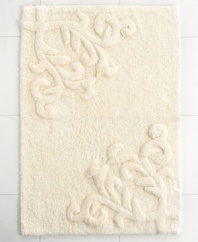Featuring one of the most elegant designs from Lenox, this Opal Innocence bath rug creates a refined look for your bathroom. Crafted with a beautiful design of scrolling vines, this tufted and carved cotton rug carries with it exceptional style and grace.