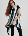 Wrap up your look with this boldly printed poncho-style scarf from DIANE von FURSTENBERG. Fringed edges lend bohemian flair.