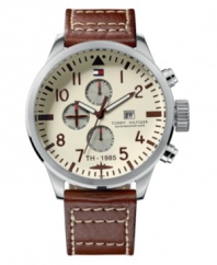 Deck yourself out with dateless style. This Tommy Hilfiger watch features a brown leather strap and round stainless steel case. Ivory dial with brown numerals, logo, date window and three subdials. Quartz movement. Water resistant to 50 meters. Ten-year limited warranty.