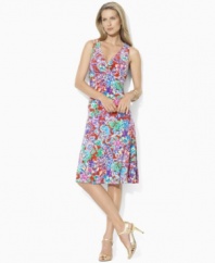 Crafted in sleek matte jersey for a full, floaty silhouette, a sleeveless empire-waist dress is adorned with a vibrant tropical-inspired print, perfect for warmer months from Lauren by Ralph Lauren.
