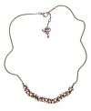 Every look could use a little bling. Fossil's sparkling fireball necklace features round-cut crystals in blush-tone hues. Setting and chain crafted in vintage brown tone mixed metal. Approximate length: 18 inches + 2-inch extender.