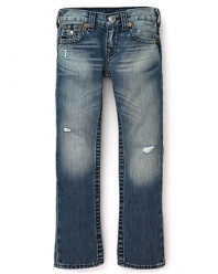 Slim-cut distressed jeans with ripped details translate to tough True Religion denim.