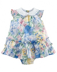 A timeless dress is adorned with sweet floral print and complimenting ruffles.
