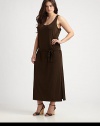 Featuring a classic dropped waist, this jersey dress features an alluring neckline and seductive side slits to draw attention to your legs. ScoopneckSleevelessSelf-tie belt at dropped waistSide slit on each sidePull-on styleAbout 38 from natural waist94% polyester/6% spandexMachine washImported