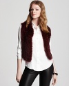 This crimson and black fur vest adds instant glamour to your days and nights--imbuing your wardrobe with luxurious appeal. Layered over the most basic button-up, this plush piece creates a dramatic impact--and you're the star of the show.