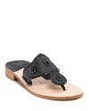 Hit the beach in these stylish leather thong sandals with whipstitched trim and floral detail along straps.