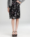Imbue your everyday look with effortless romance in a DKNY skirt blooming with dark florals and dramatic pleats.