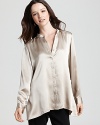 A flowing silk charmeuse Eileen Fisher boxy shirt is cut in a relaxed silhouette for everyday ease and comfort.