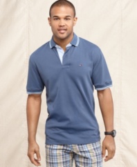 Nothing tops the classic look of this solid polo shirt from Tommy Hilfiger.