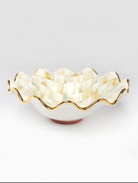 This remarkably unique bowl, in hand-painted terra cotta with color-dragged checks and golden trim, creates an ultra-glamorous presentation piece for you and your guests.Ceramic with golden lustre14.5 diam.Hand washMade in the USA