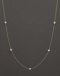 A yellow gold necklace with bezel-set diamond stations. With signature ruby accent. Designed by Roberto Coin.