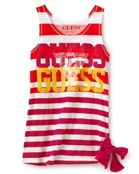 GUESS updates her summer look with a tank top, tricked out with variegated stripe patterns, distressed GUESS logo lettering and bow tie at the side hem.