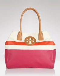 Perfect preppy accessorizing with this coolly color blocked tote from Tory Burch. Whether you're beach bound or simply running errands in the city, this durable canvas bag is ideally sized to carry it all.