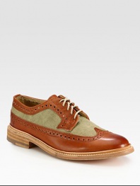 Classic wingtip style gets a contemporary update with contrasting textures, rendered with a smooth, genuine leather finish.Leather/canvas upperLeather liningPadded insoleLeather soleImported