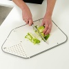 The patented Rinse & Chop Joseph Joseph chopping board folds to create a strainer at one end, and a chute at the other. Fold and lock the board into position to rinse; open and flatten to chop, then fold again to pour food easily into a pan.
