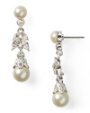 Forgo the garden variety jewels in favor of Carolee's delicate floral teardrops. Come party time, these pearl and crystal-adorned earrings dazzle set against a simple sheath dress.
