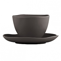 Featuring an organic shape and a matte glaze finish, this bowl and saucer are thoroughly modern and impart natural sophistication.