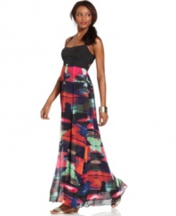 Jessica Simpson takes the maxi silhouette from boardwalk to the ballroom with this striking dress. An open back is highlighted by slender crisscrossing straps and the solid bodice sets off the bright print of the chiffon skirt.