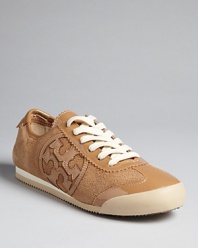 Tory Burch makes sneakers chic, embellishing a sleek, suede silhouette with her signature logo.