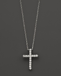 Diamonds, set in 14K white gold, form a chic cross.