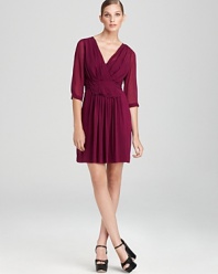 Sheer sleeves and delicate pleats infuse this DKNY dress with romantic inspiration, while a tie belt lends a flattering, feminine finish.
