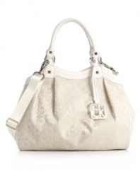 In logo jacquard fabric with an optional crossbody strap, the monogram Hudson purse by Calvin Klein dresses up or down.