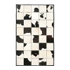 The bold black and white cowhide patchwork motif on this Ralph Lauren rug warms your living space with a sleek interpretation of Western style.