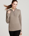 Play it cool in neutrals with this Nike half-zip top. A neon-pop collar lends a bold touch to the performance piece.