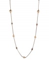 Delicately decorated with mocha glass pearls and smokey quartz-hued crystals, Givenchy's single-strand long necklace epitomizes understated elegance. Crafted in brown gold tone mixed metal. Approximate length: 36 inches.