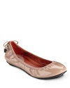 A sleek silhouette and feminine lace-up detail make these your must-have flats. From Cole Haan.