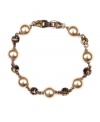 Rich brown hues take center stage on Givenchy's stretch bracelet, which spotlights mocha glass pearls elegantly enhanced by smokey quartz-colored crystals. Crafted in brown gold tone mixed metal, its stretch design offers a flexible fit. Approximate length: 7-1/2 inches.