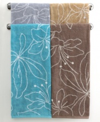 Your bath, in bloom. Featuring a stencil design of modern lilies, this Bianca hand towel blossoms in refreshing hues and soft terry. Contrast pattern on reverse.