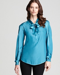 Feminine tailoring lends romantic inspiration to this Rachel Roy blouse, finished in a decadent jewel tone for effortless elegance.