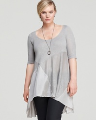 Subtle color blocking and an asymmetric hemline lend modern appeal to this Eileen Fisher Plus tunic. Balance the breezy silhouette with sleek separates for effortless sophistication.