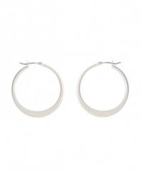 Shimmery hoops with a modern spin. Kenneth Cole New York earrings feature a graduated hoop in silver tone mixed metal. Approximate diameter: 1-1/4 inches.
