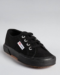 Superga updates its iconic look in black canvas, for a classic summertime look.