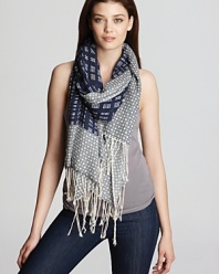 A stylish pairing of plaid and polka dot embellish this luxuriously soft scarf from Tory Burch.