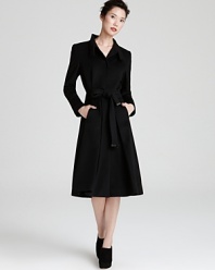 Wrap up in chic style with this sleek-cut Escada coat rendered in warm wool.