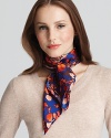 A colorful patchwork of floral patterns create a lovely and stylish silk scarf from Charlotte Sparre.