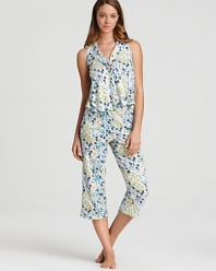 A colorful floral print pajama set with a sleeveless top and matching wide leg capri pants.