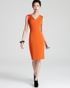 Add color to your closet with this boldly-hued Escada dress with sunburst seaming detail and a structured silhouette.