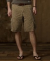 A classic cargo short in durable cotton canvas upholds its rugged roots with ripped-and-repaired stitching and a sun-faded camo print, adding a vintage quality to a modern man's essential.