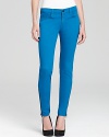 Exposed zips at the ankles lend edge to these J Brand skinny jeans, rendered in a pop-bright hue.
