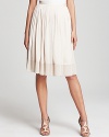 Brimming with ladylike charm, this pleated DKNYC skirt flaunts a flouncy silhouette in an elegant nude hue. Pair with delicate sandals for classic feminine appeal.
