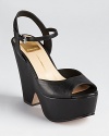 A cut-out wedge lends forward style to these chunky Dolce Vita platforms, rich in jet black leather.