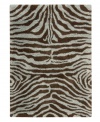 Exotic designs will be the pride of your decor. Adorned with zebra stripes in aqua blue and brown, this Nourison rug has a marvelously soft and shaggy pile that's hand-tufted from premium-quality yarns. Beautiful in appearance and plush underfoot, this area rug creates an atmosphere of casual elegance.