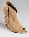 A peep toe bootie gets the fringe treatment on STEVEN BY STEVE MADDEN's soft suede Samaraa wedges.